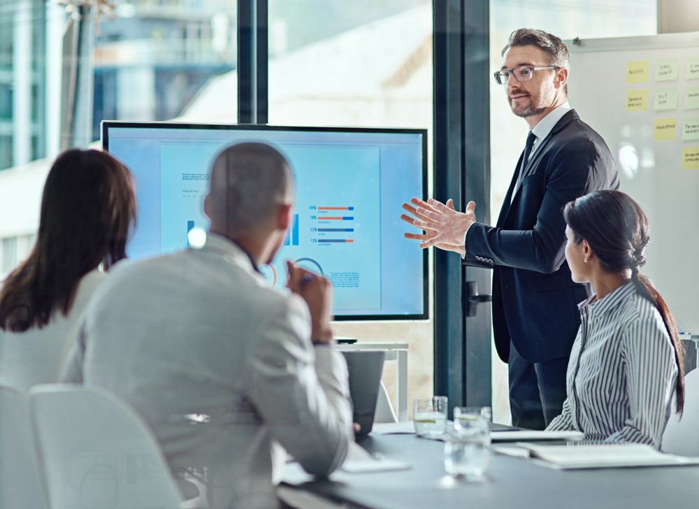 Benefits consultant presenting to a team in an office
